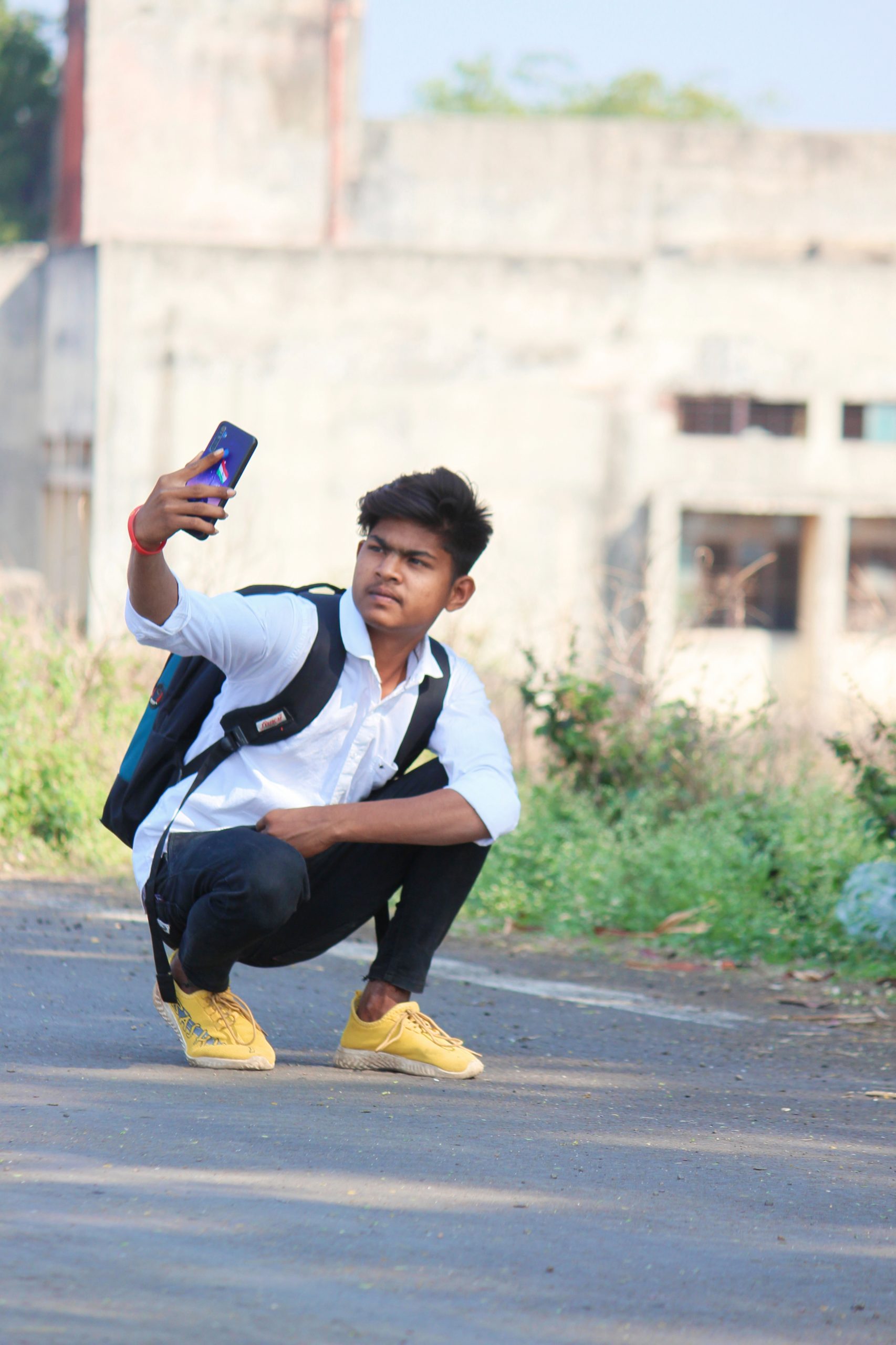 A boy taking selfie on road