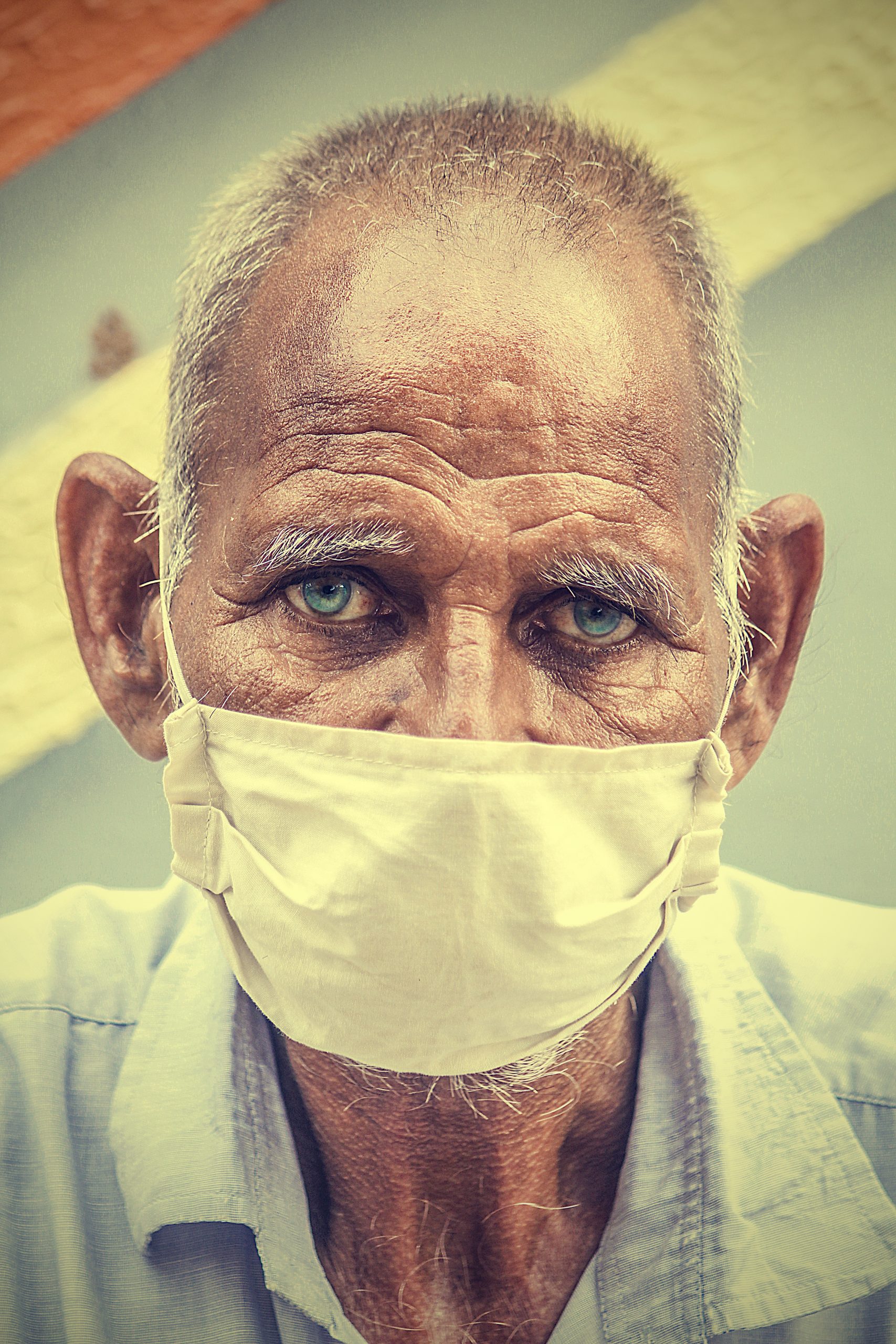 An old man with face cover