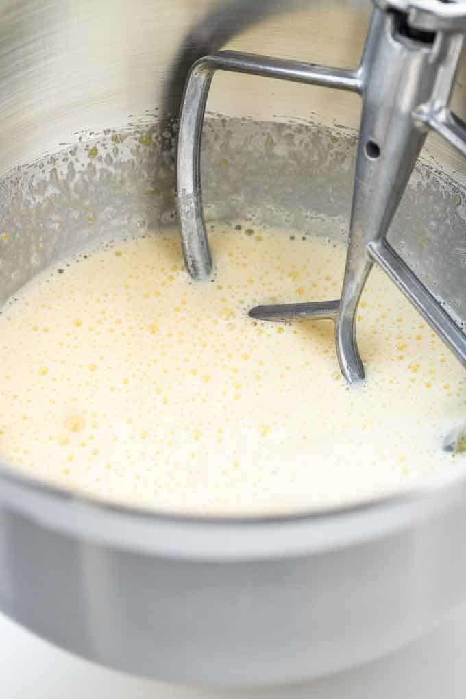 Cake batter in a stainless steel kitchen aid bowl with the flat beater in it.