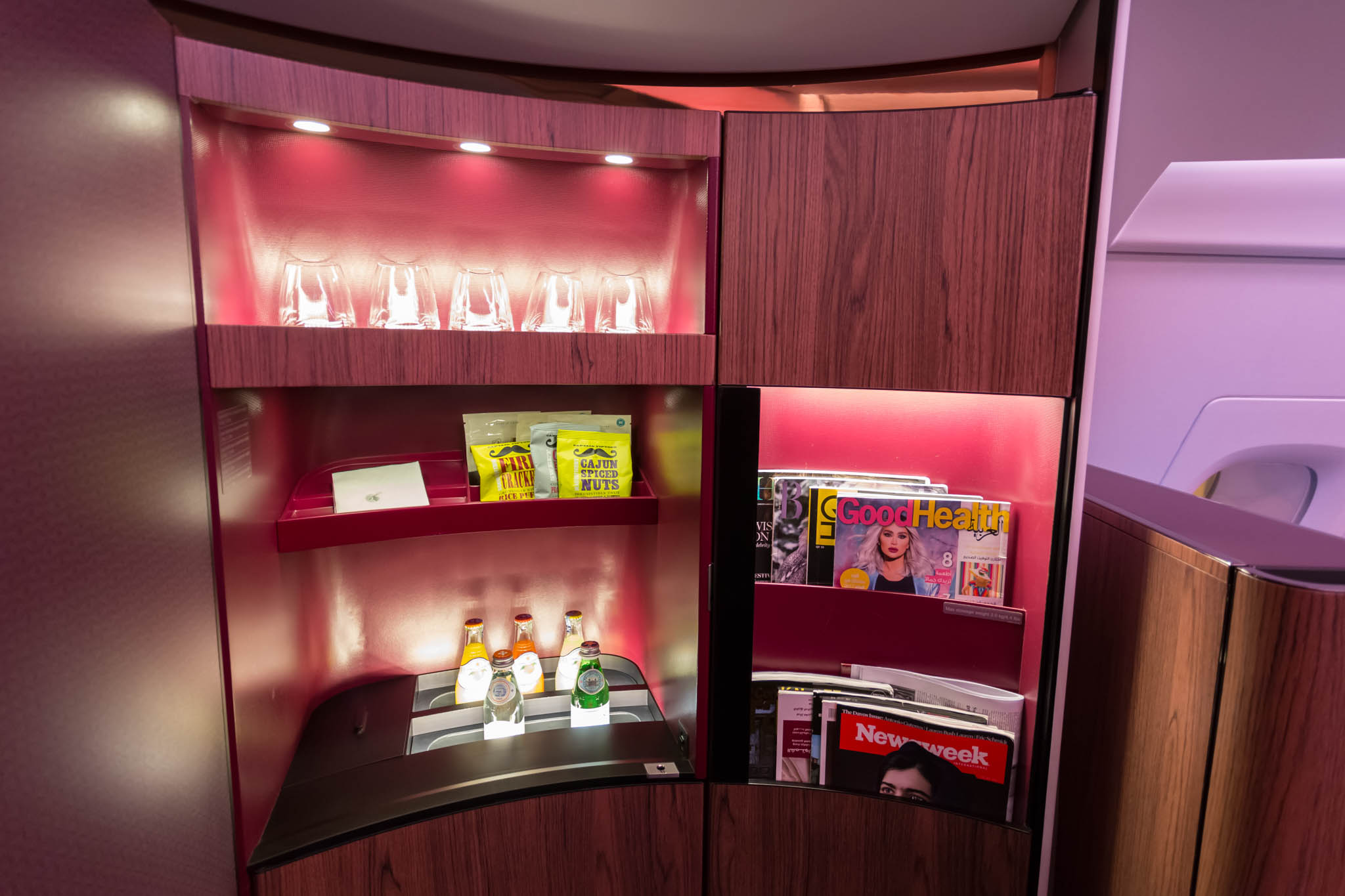 a shelf with drinks and magazines