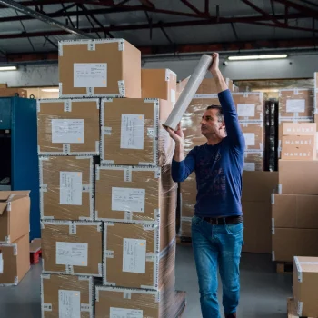 Factory worker packing the goods for delivery.