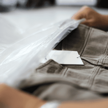 Factory worker packing and labeling sneakers.