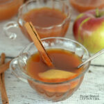 hot apple cider tea in a tea cup with a cinnamon stick