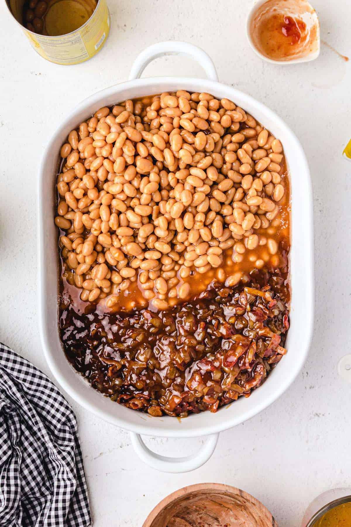 beans and frying pan contents poured into the same baking dish