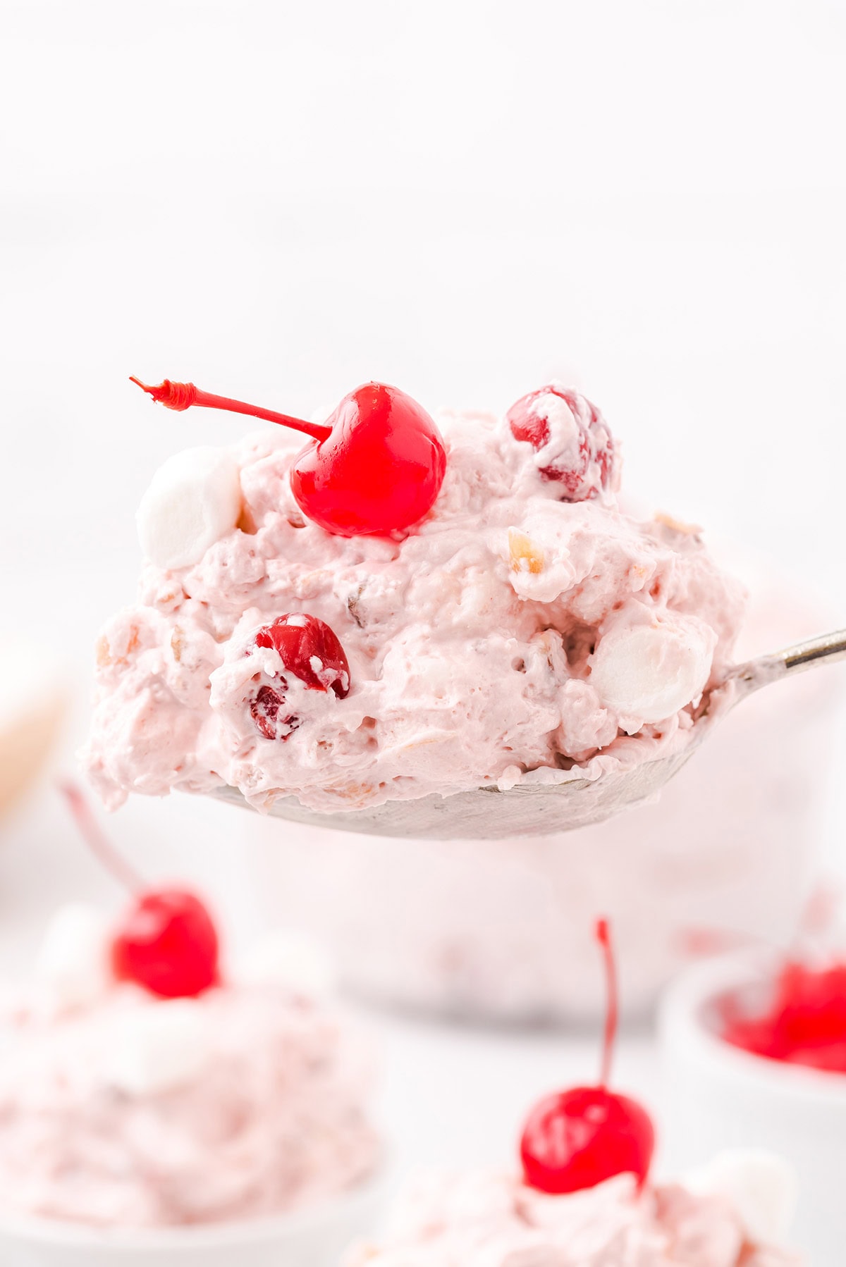 A spoonful of cherry fluff dessert.