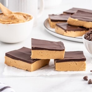 Buckeye Bars stacked on top of parchment paper.