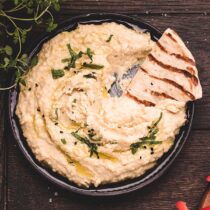 hummus in a black bowl.