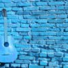 Blue Guitar on Brick Wall