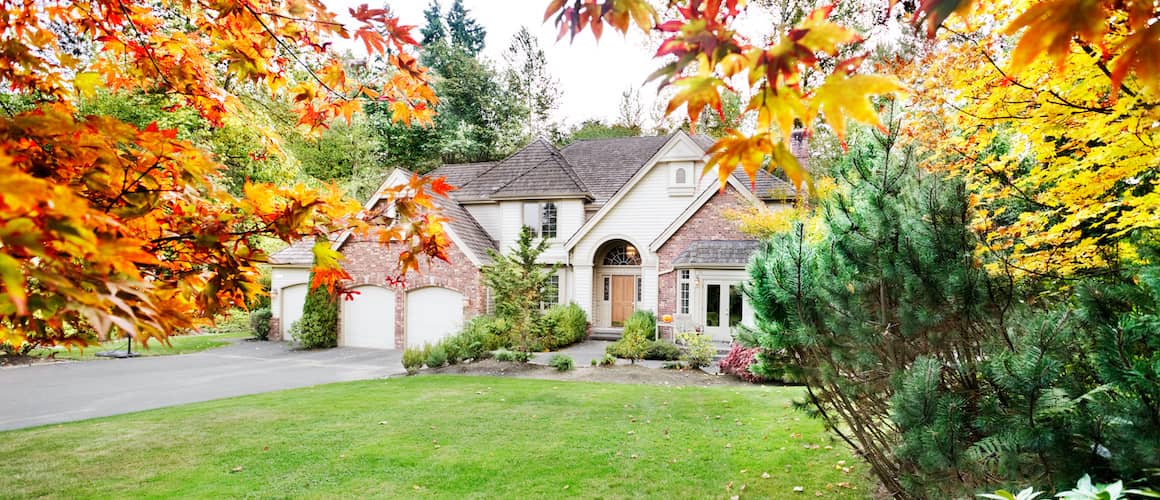 RHB Assets From IGX: Suburban home seen through fall leaves