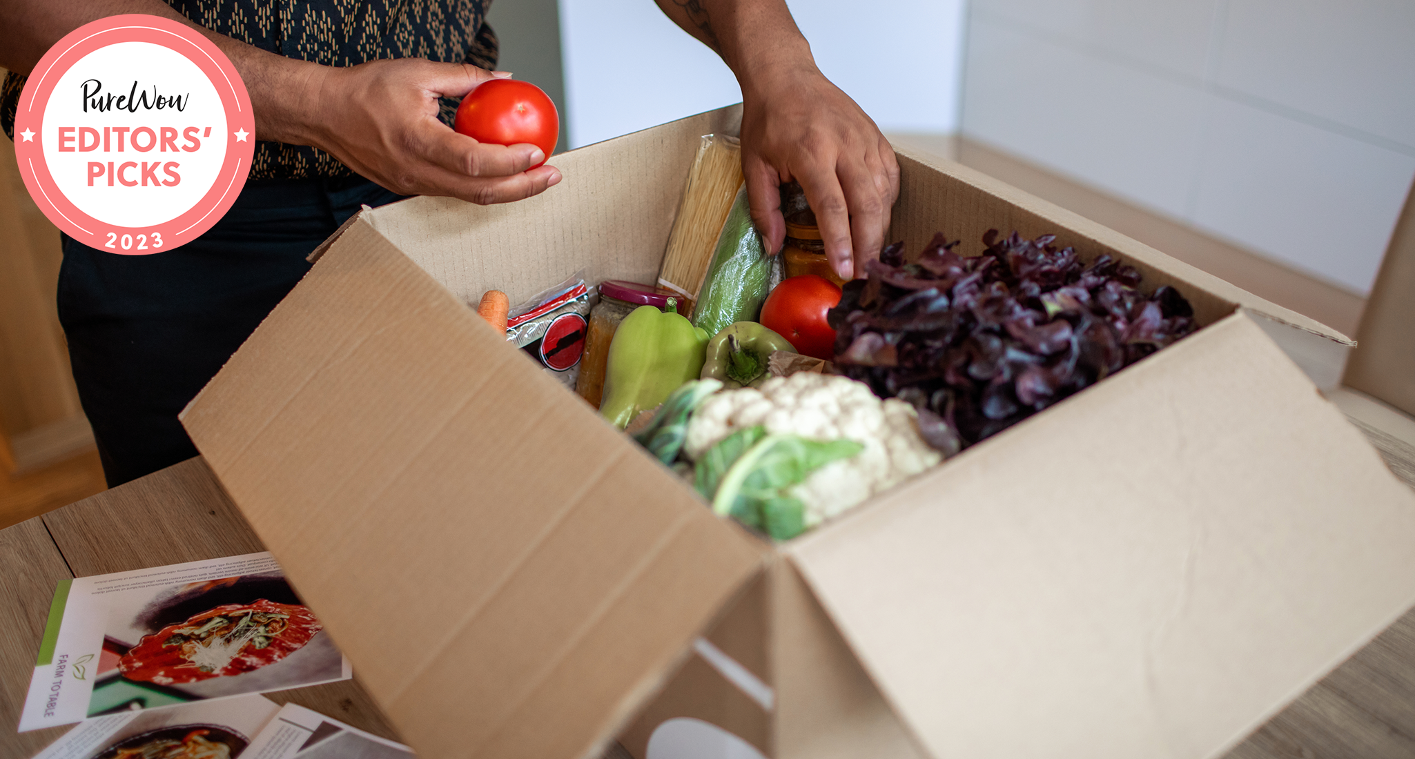 best low carb meal delivery: a person unboxing vegetables from a low carb meal delivery kit