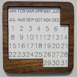 Puzzle Calendar - solve for each day of the year (cherry pieces and walnut border)