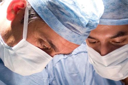 a photo of surgeons in an operating theatre