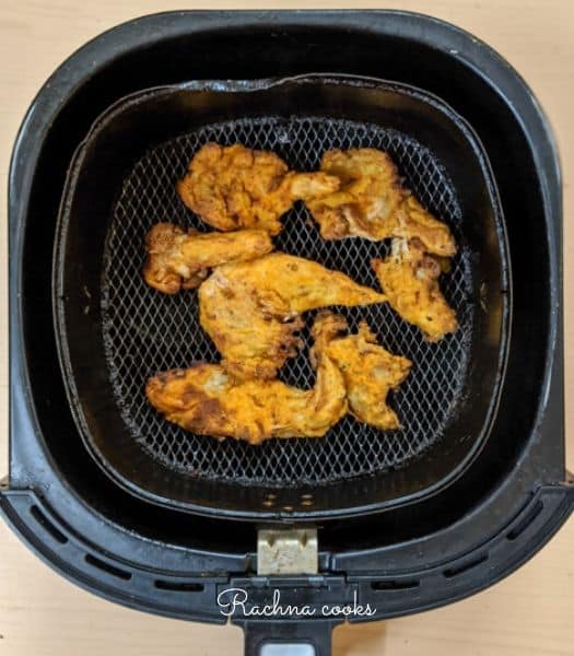 Crunchy golden oyster mushrooms after air frying in air fryer basket.