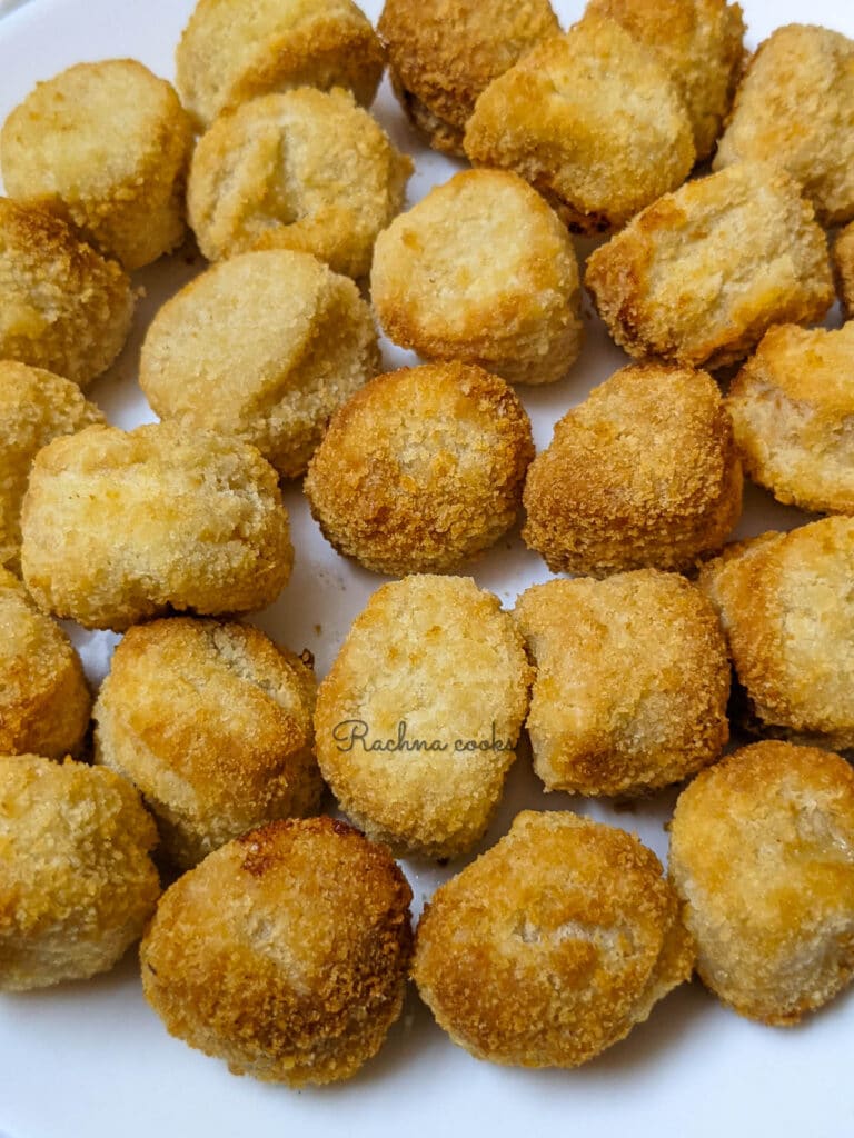 a close up shot of golden popcorn chicken already air fried