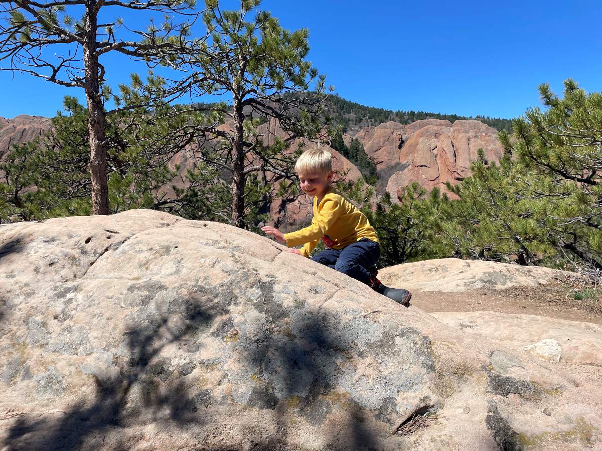 boy climbing on rocks