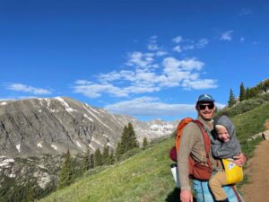 Dad carrying child in lightweight carrier for hiking