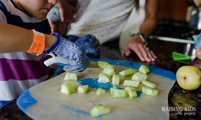 boy cutting cucumbers