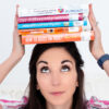 parent coach holding parenting books on head