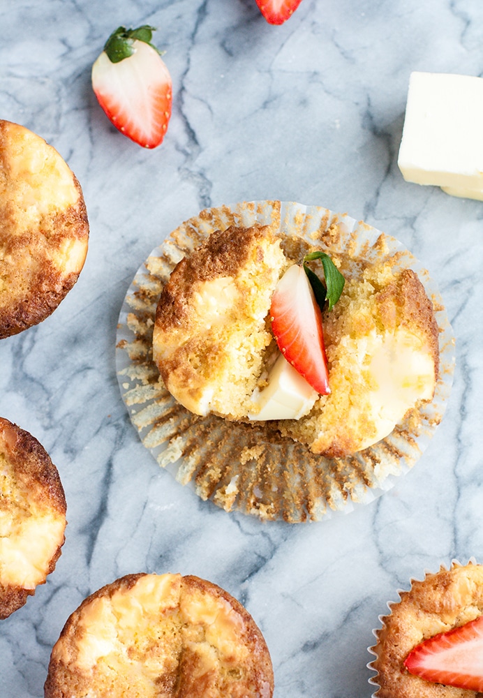 overhead shot of strawberry cream cheese muffin torn in half