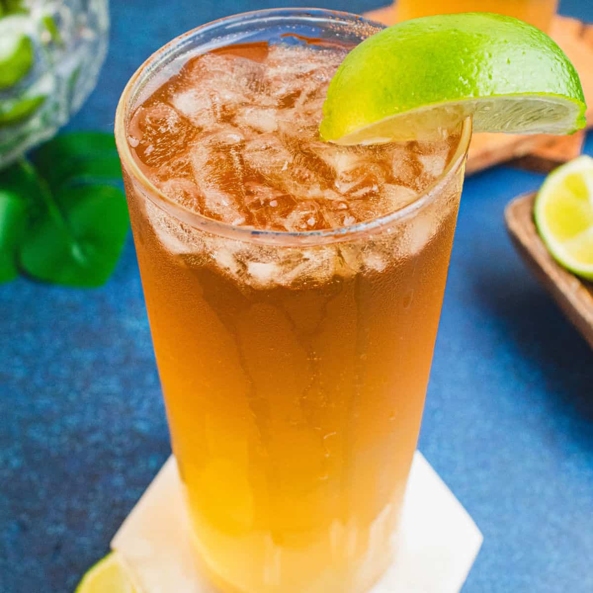 square image of a dark and stormy cocktail garnished with a lime wedge