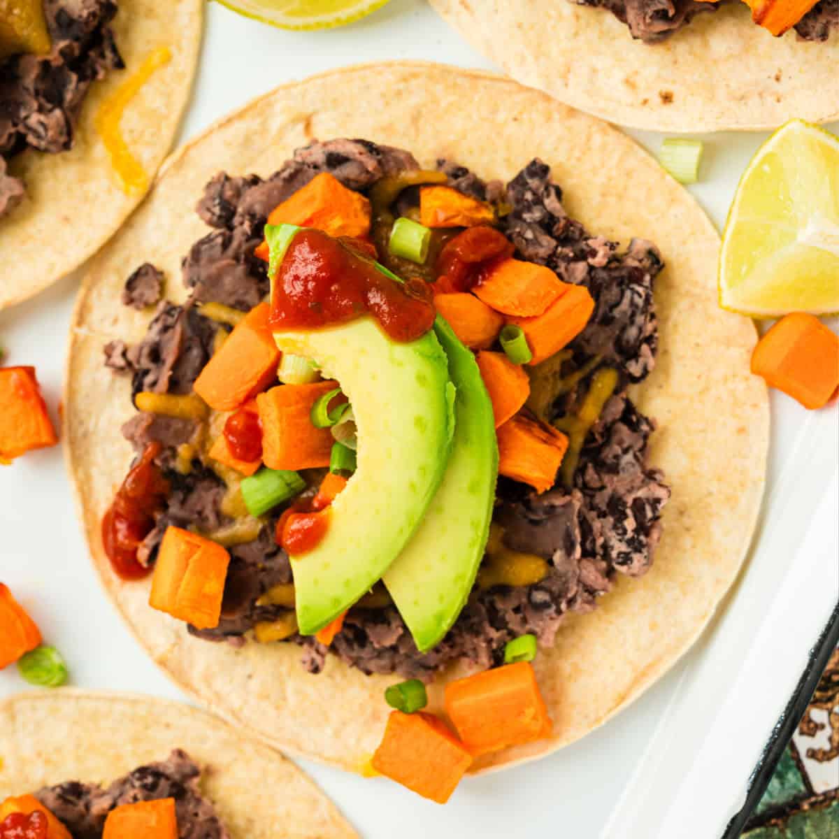 square image of a roasted sweet potato tostada on a platter