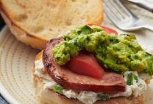 ham bagel with smashed avocado, tomato, and roasted jalapeno cream cheese