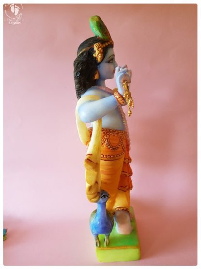 Krishna deity 15 inch white marble side view on pink background