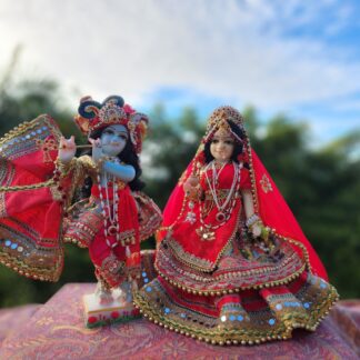 Radha deity wearing shadi colored red shringar carved from marble 12 inch deity with full opulent shringar radha festival deity wearing red Krishna deity dressed for wedding