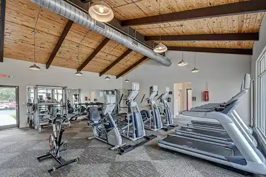 workout area featuring carpet and lofted ceiling with beams