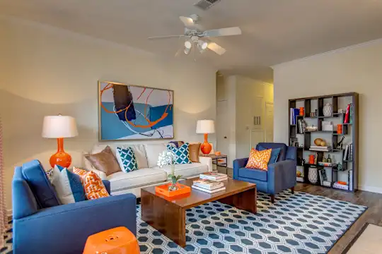 living room featuring hardwood floors and a ceiling fan