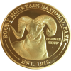 A Collectible Coin - RMNP Gold Ram with a ram on it.