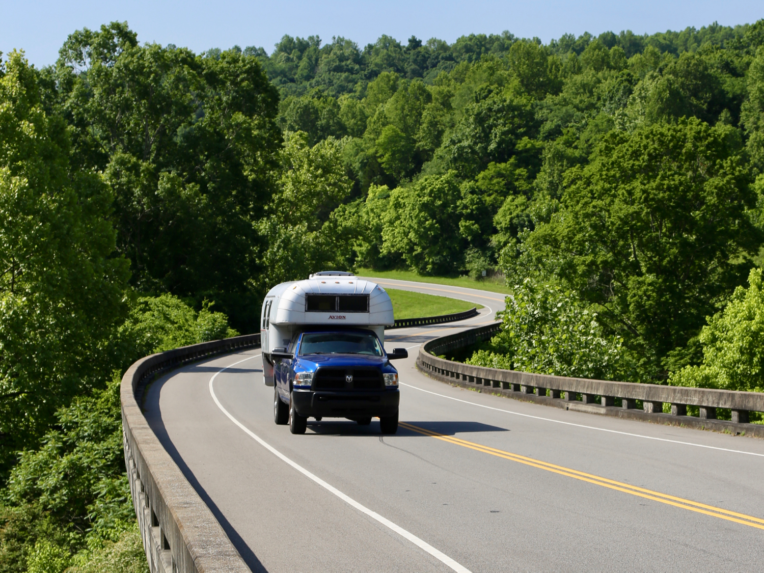 Aluminum truck camper on a blue truck on the Natchez Trace