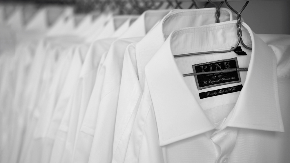 black and white photo of white button down shirts.