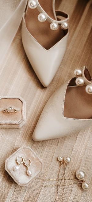 Luxe pearl and gold wedding necklace, earrings and hair pins with a diamond engagement ring and white pearl wedding shoes