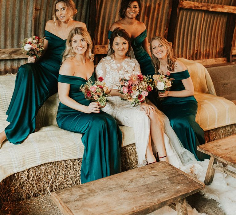 Autumn themed wedding with bridal party wearing emerald green bridesmaid dresses 