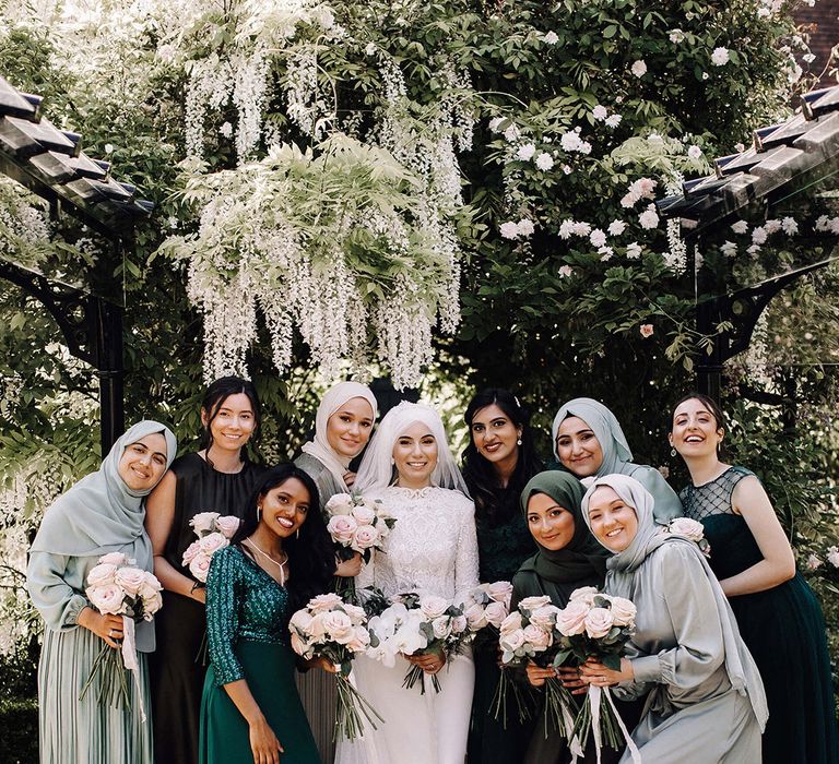 Wedding party wearing different shades of green wedding outfits for green wedding theme ideas 