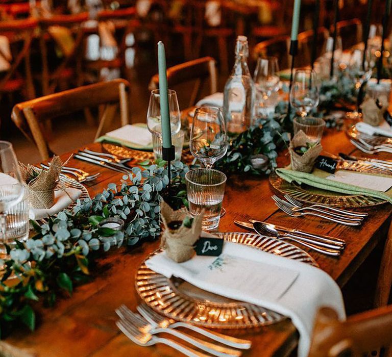 Silchester Farm rustic wedding with foliage table runner, green candles and succulent wedding favours for green wedding theme 