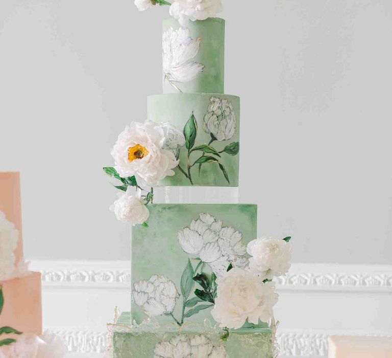 Four tier mint green and white flower wedding cake with white flowers for green wedding theme ideas 