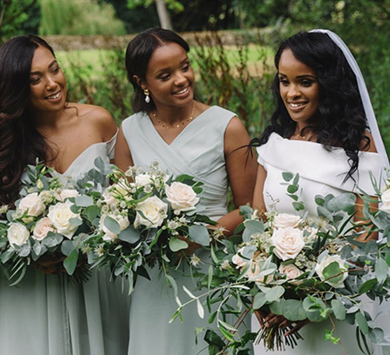 Bridesmaids in mismatched style bridesmaid dresses in matching shades of mint green for Sudanese wedding 