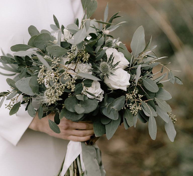 White wedding flower bouquet with eucalyptus foliage 