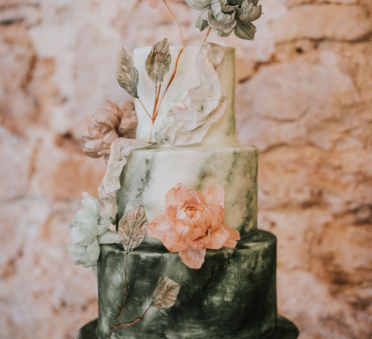 Green hand-painted iced wedding cake for green wedding theme ideas roundup with pink flowers 