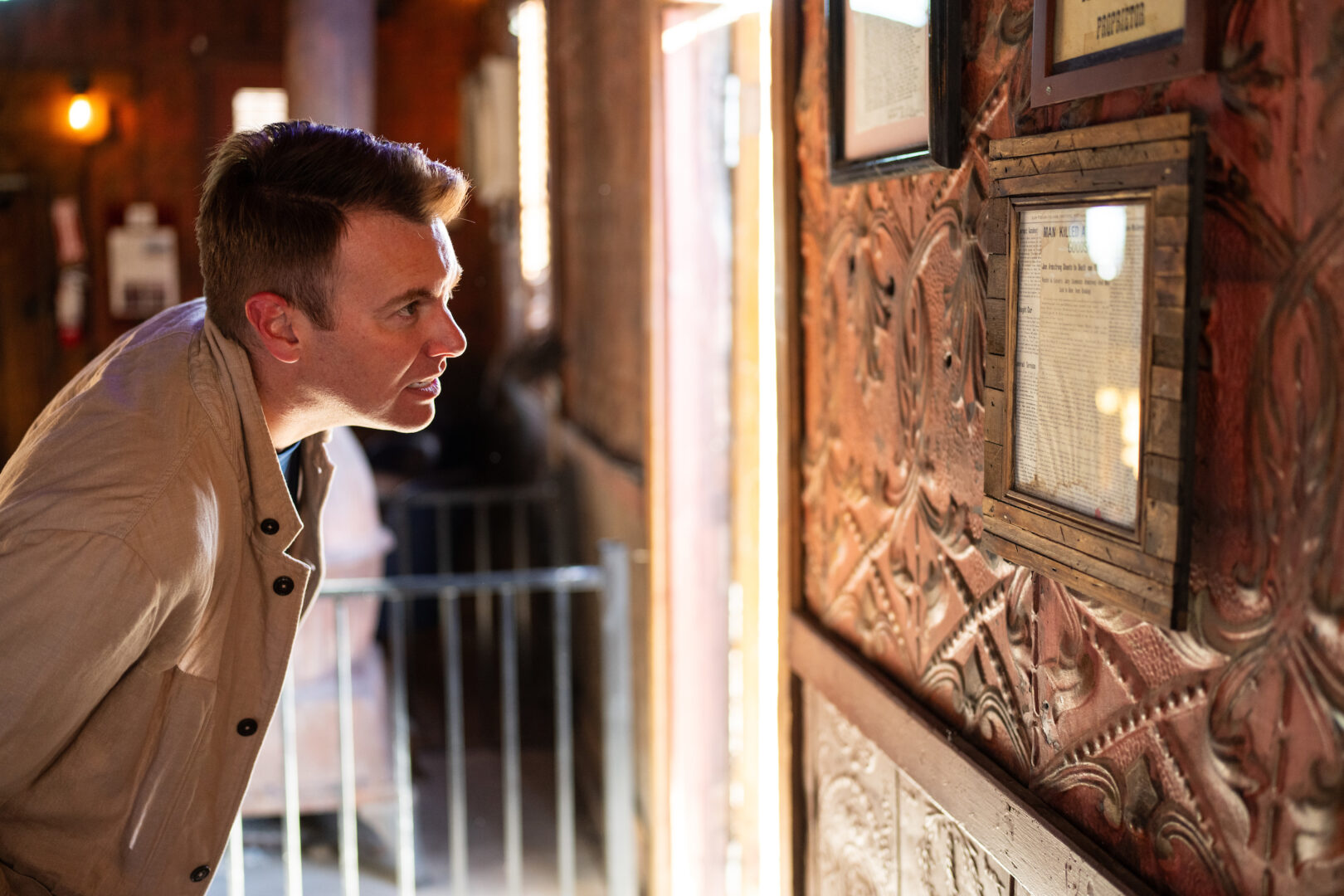 Drew Johnson, a Republican candidate in Nevada’s 3rd District, looks at bullet holes in the tin wall from a deadly 1915 poker game during a tour of the Pioneer Saloon in Goodsprings, Nev., where he was holding a meet and greet on May 28.