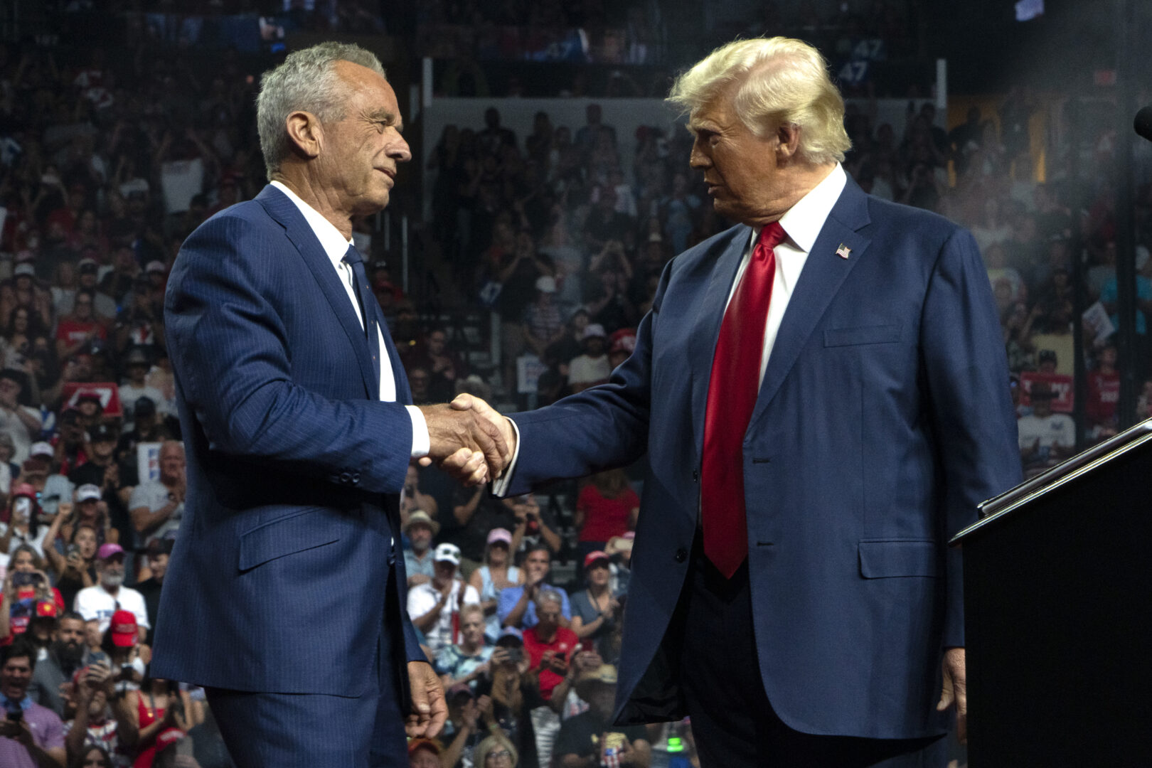 President-elect Donald Trump shakes the hand of his choice to serve as secretary of Health and Human Services, Robert F. Kennedy Jr., during the 2024 presidential campaign.