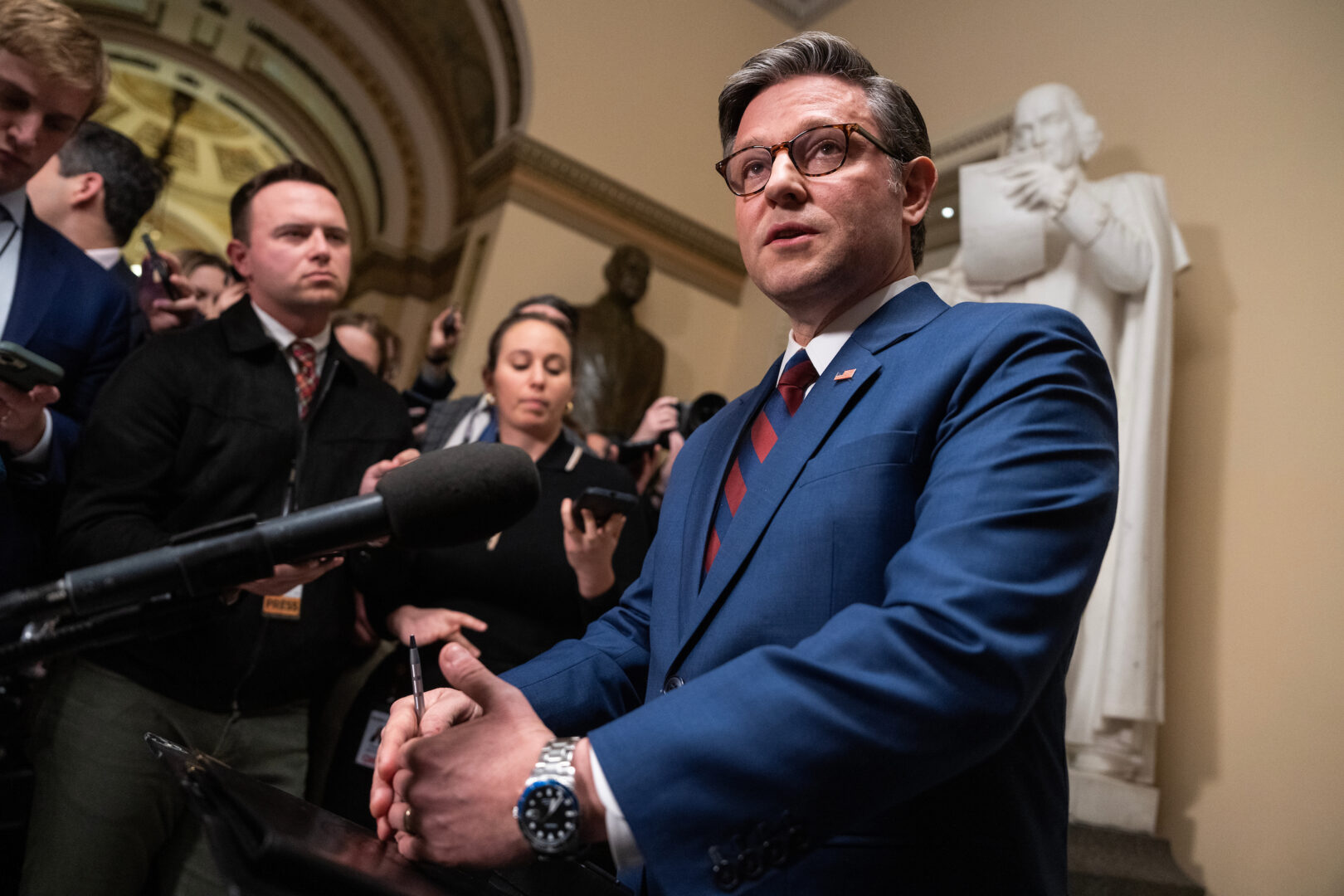 Speaker Mike Johnson, R-La., talks with the media in the Capitol on Thursday before a vote on a continuing resolution to fund the government.