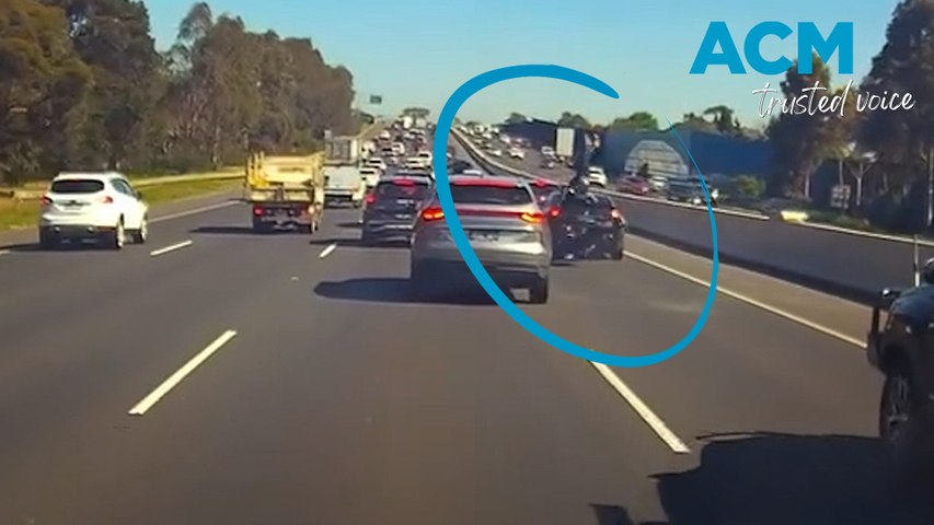 A motorcyclist has survived a hairy collision after somersaulting onto the roof of a car on a busy highway in Melbourne, Victoria. Vision courtesy: Dash Cam Owners Australia