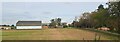 TL9864 : Barns at Elmswell Hall, from the railway by Christopher Hilton