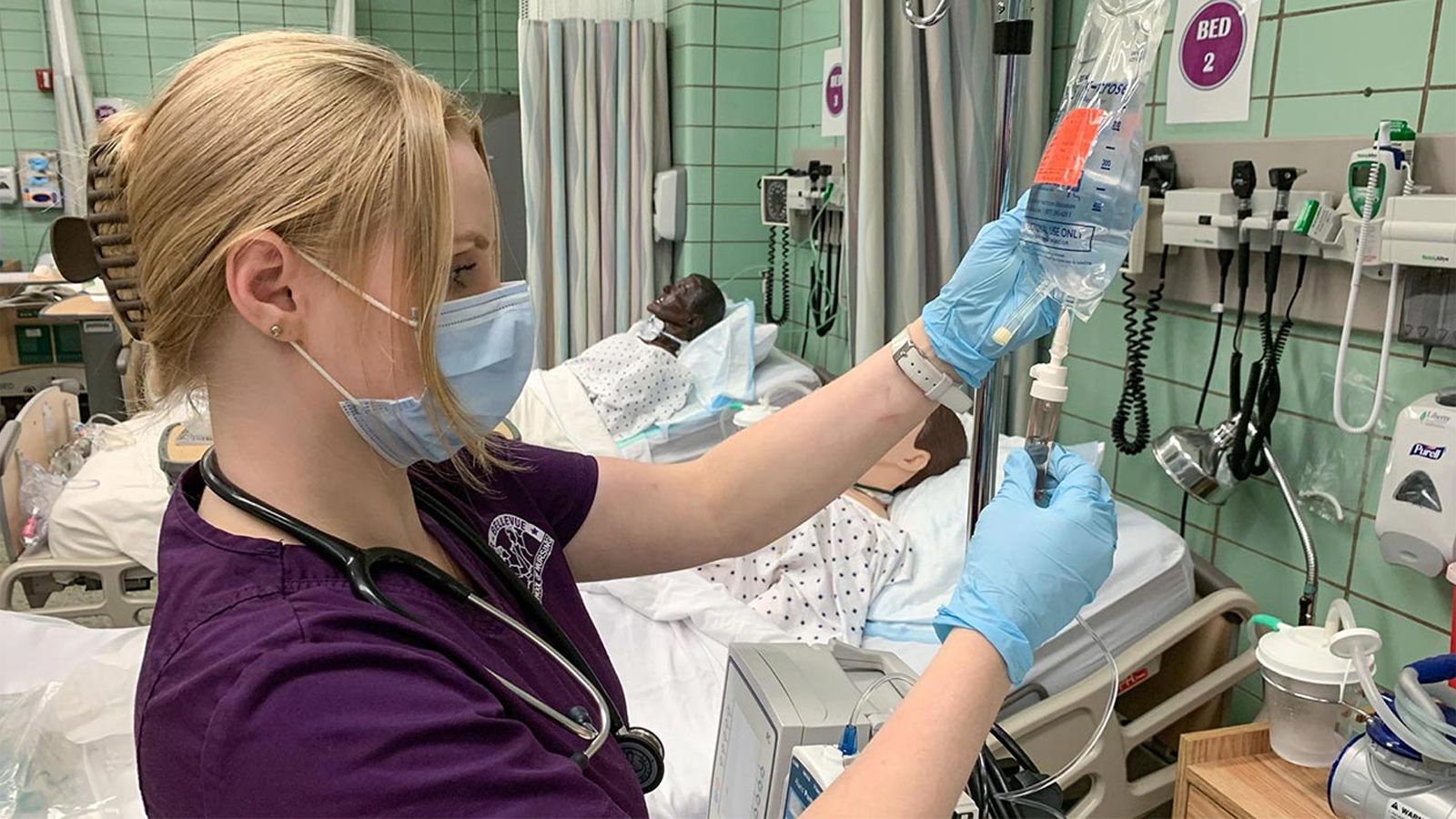 Nursing student holding up an IV