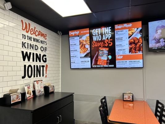 Photo of Wing It On! - Waterbury, CT, US. a dining area with a table and chairs