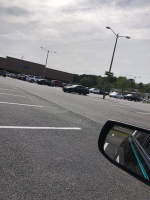 Photo of Food Lion - Moyock, NC, US. a view of a parking lot from a car's side mirror