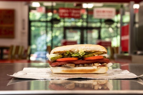 Photo of Five Guys - New York, NY, US. A Five Guys hot dog sits on the counter in a Five Guys restaurant.